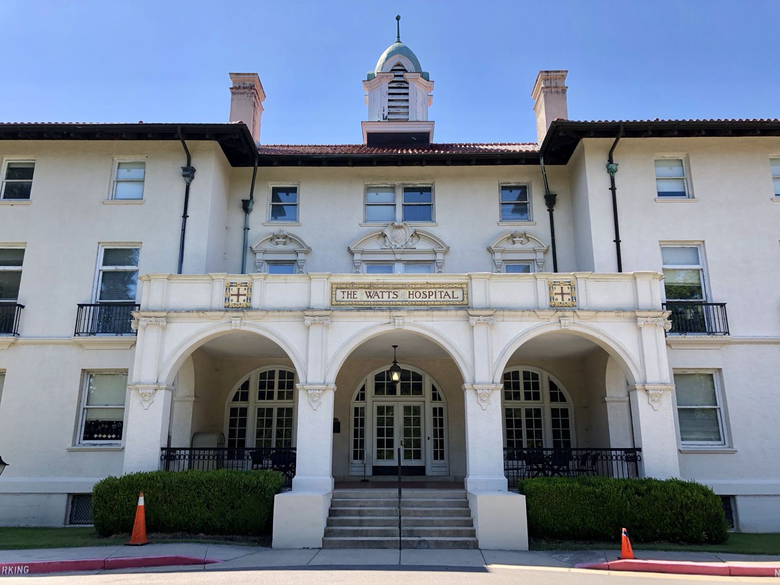 Watts Hall, a white stucco building with arched entrances, on the NCSSM campus in Durham